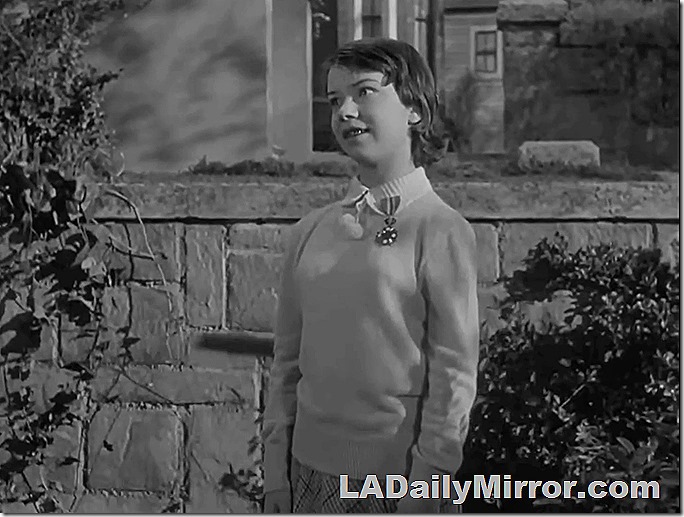 Young girl with braces on her teeth. A medal is pinned to her sweater. Young girl with braces on her teeth. A medal is pinned to her sweater.