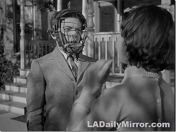 Boy in coat and tie, wearing catcher's mask. Boy in coat and tie, wearing catcher's mask.