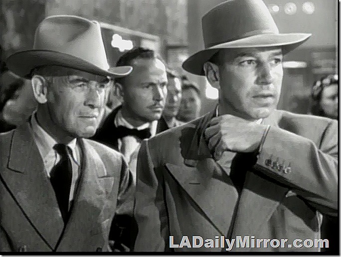 Two men in hats and suits. They do not approve of such goings-on