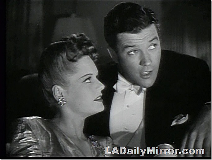 Elegantly dressed woman and man in tuxedo. 