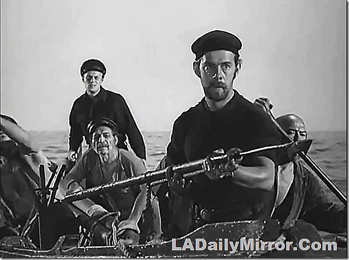 Men in a boat, gazing intently. 