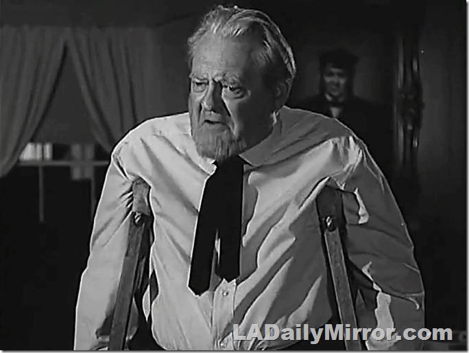 White-haired man with beard, on crutches. 