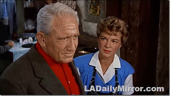 Man in suit coat, woman in blue top