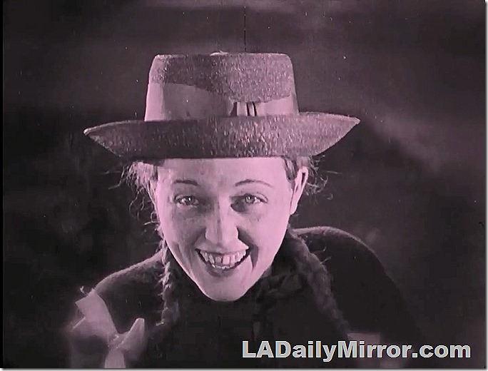 Mysterious leading lady, wearing hat, her hair in pigtails. 