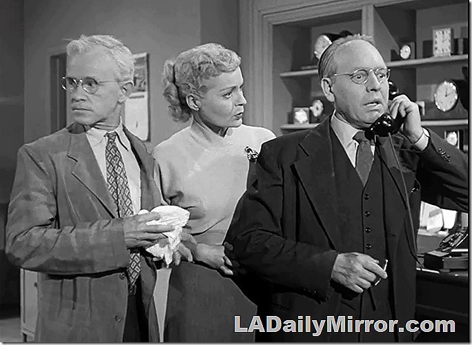 Mystery man, rather upset, on phone. A mysterious woman listens while another mysterious fellow looks around, a bit puzzled. Mystery man, rather upset, on phone. A mysterious woman listens while another mysterious fellow looks around, a bit puzzled.