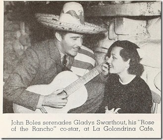 John Boles, in suit, serape and sombrero, serenades Gladys Swarthout at La Golondrina.