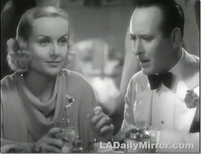 Blond woman in elegant dress with man in white dinner jacket. 