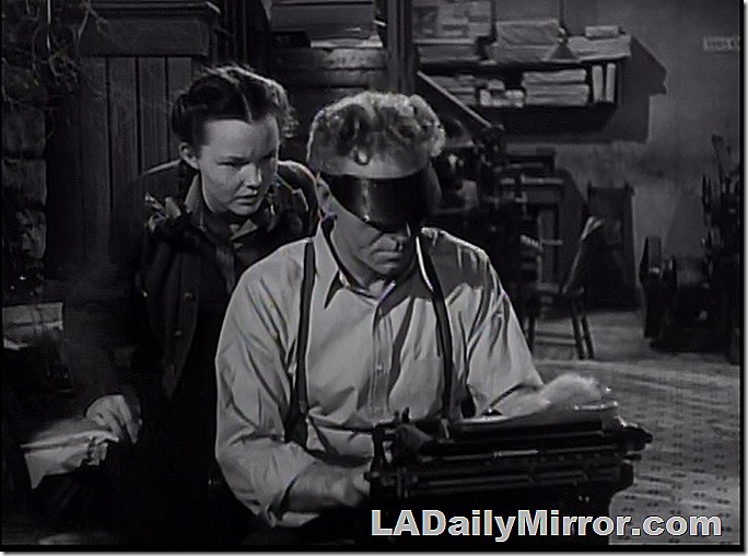 A mysterious newsman! And woman companion. 