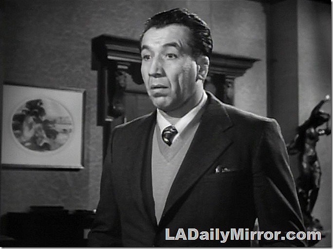 Mysterious man in coat, sweater and tie with a quizzical look on his face. 