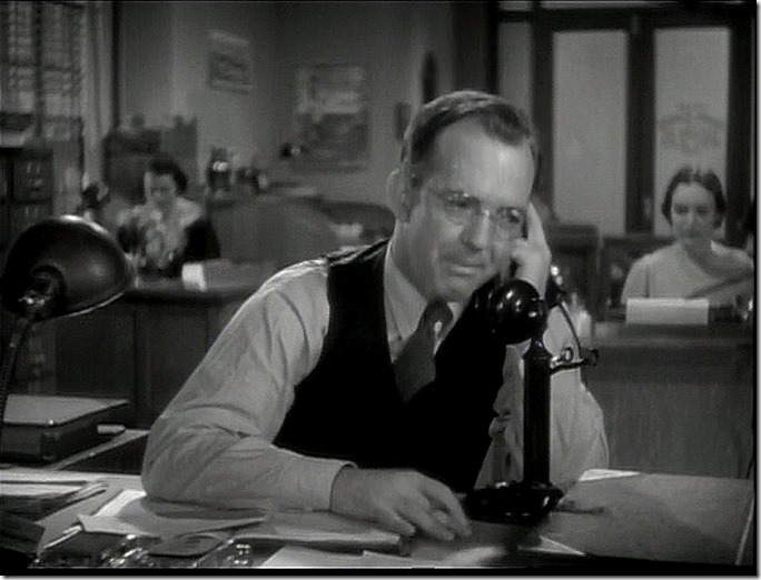 Man in vest on the telephone. 