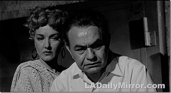 Mystery woman with mysterious man. Very grim expressions on both. 