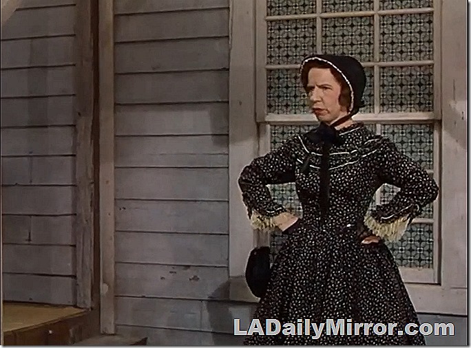 Woman in long dress and bonnet