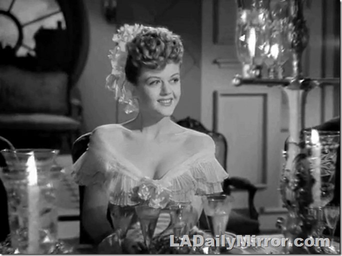 Pretty young woman, fashionably dressed with plunging neckline. 