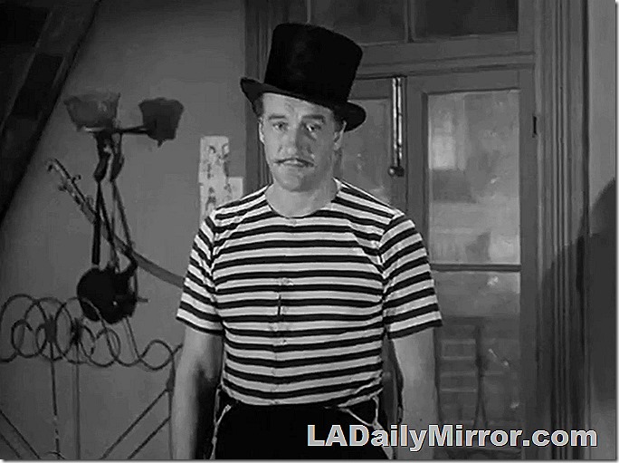 Man with mustache, wearing top hat and T-shirt.