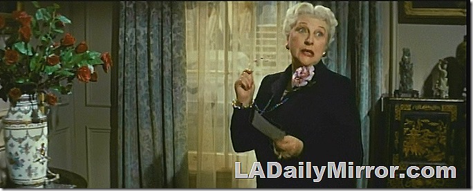 Elegant older woman holding piece of paper. 