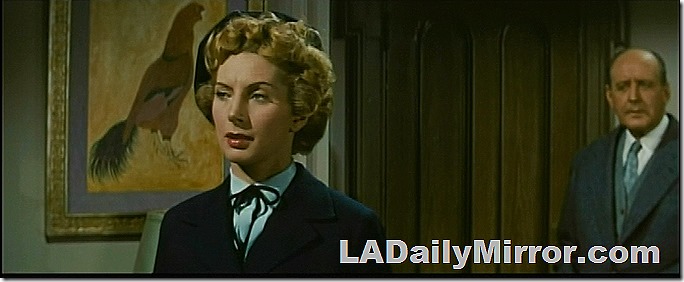 Fashionably dressed woman in beret, unfocused man hovering in the background