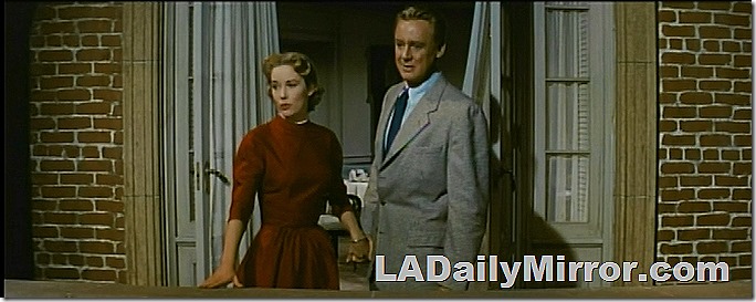 Man and woman on balcony overlooking London. 