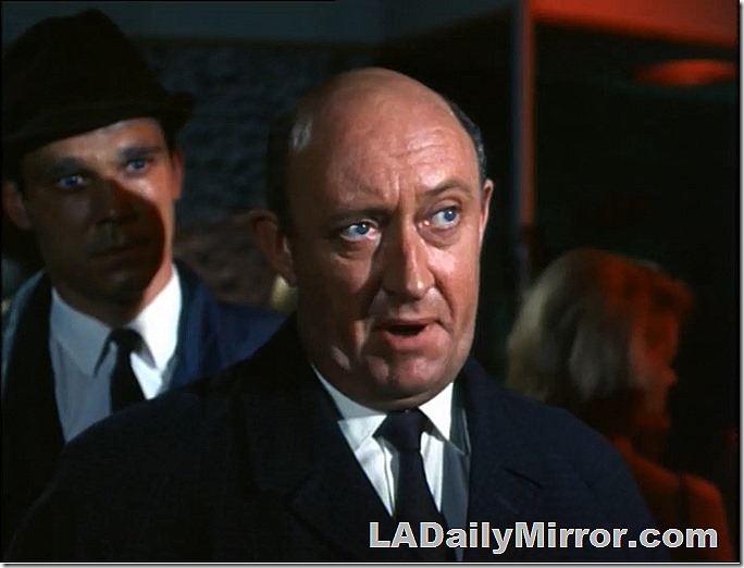 Bald man in coat and tie. He does not approve of such goings-on. 