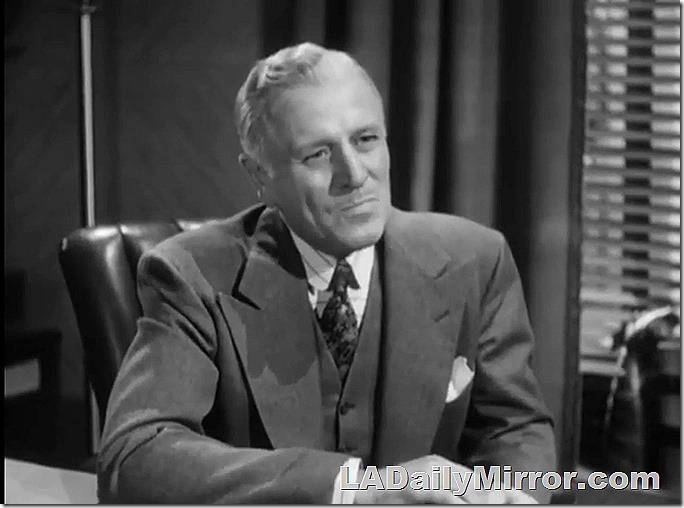 Dignified man in three-piece suit sitting at desk. Dignified man in three-piece suit sitting at desk.