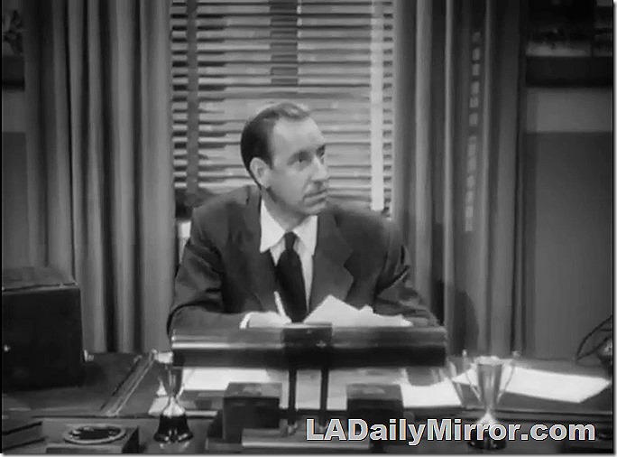 Man in coat and tie, sitting at desk. Man in coat and tie, sitting at desk.