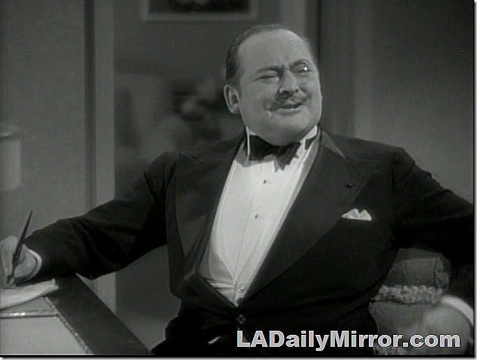 Man wearing monocle, with slight mustache, in tuxedo