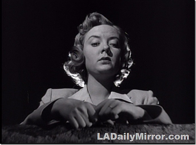 Mysterious woman in a pensive mood at night. She's backlit. 