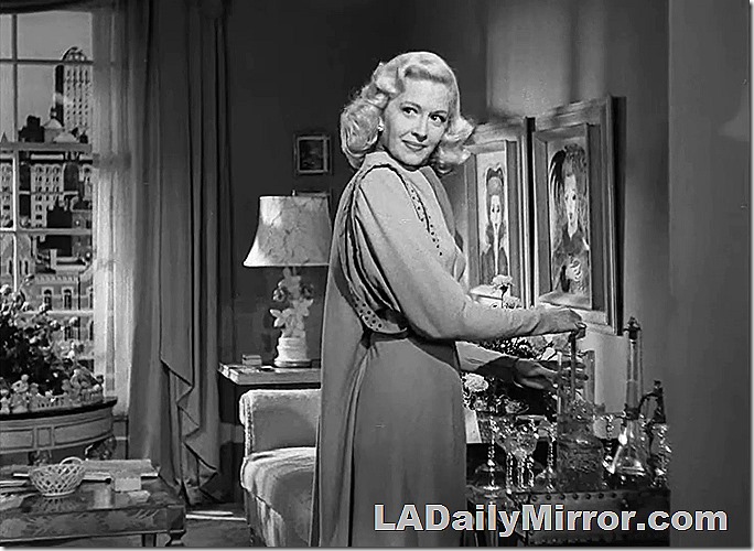 Elegant lady in swank apartment. She is mixing cocktails. 