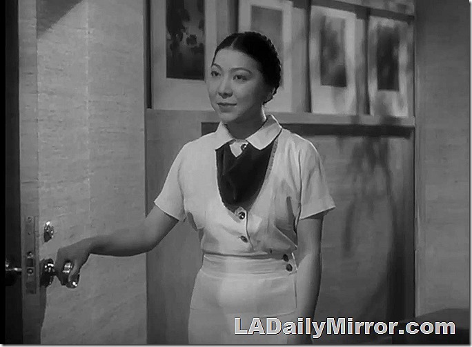 Fashionably dressed woman standing in doorway, 