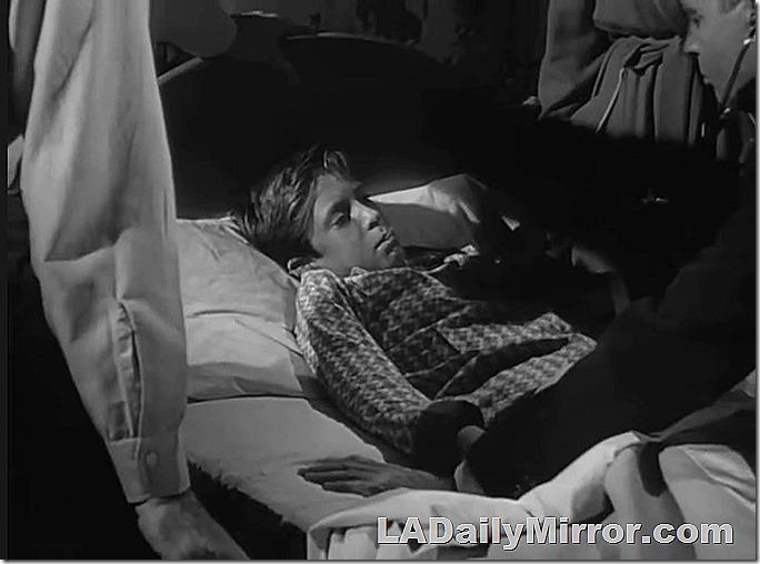 Boy in bed with thermometer in mouth