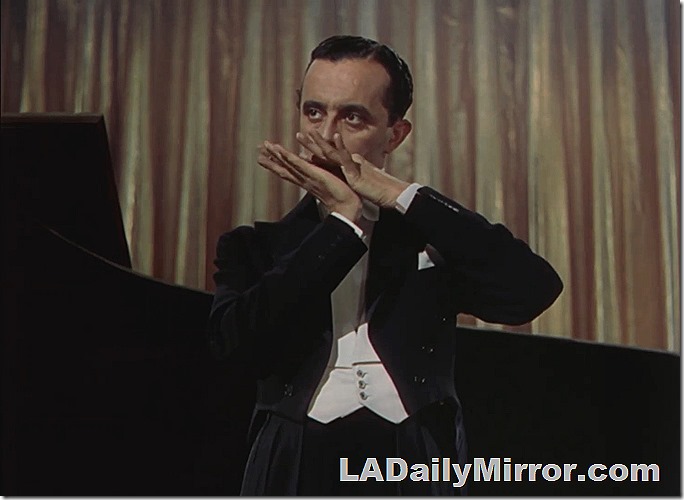 Mysterious man in tuxedo doing something very mysterious.