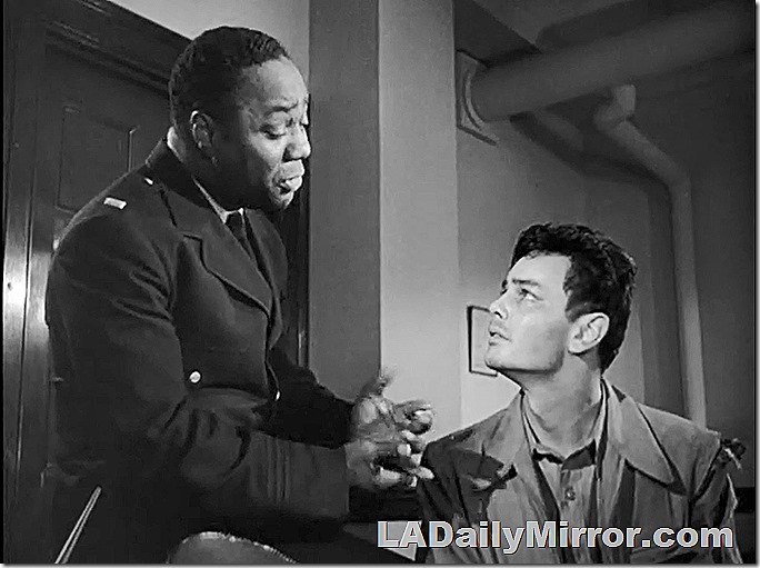 Man in uniform talks to man in jacket. Man in uniform talks to man in jacket.