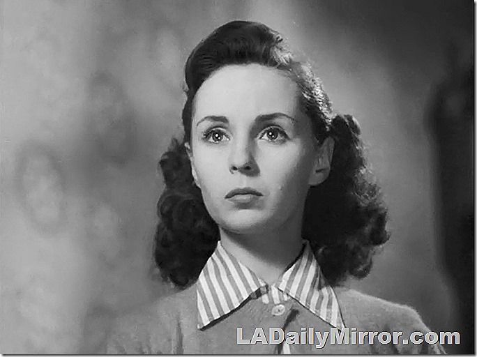 Woman with shoulder-length hair in sweater and blouse. Woman with shoulder-length hair in sweater and blouse.