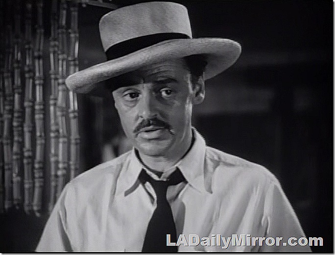 Man with mustache and tie, wearing large hat. Man with mustache and tie, wearing large hat.