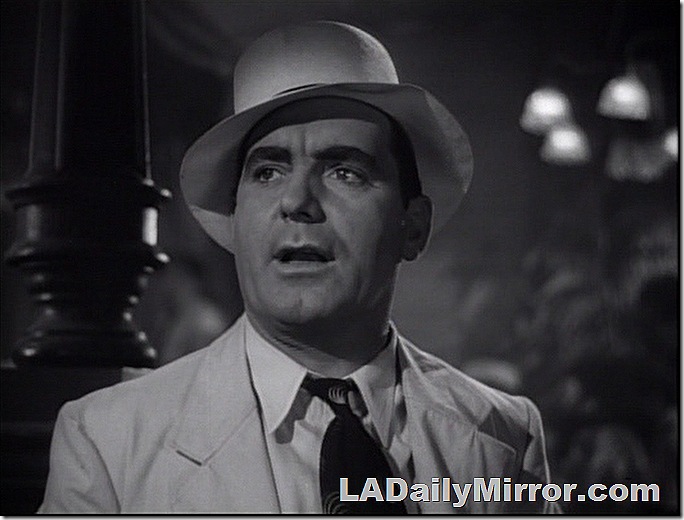 Man in tropical suit and hat, tie pulled loose at the collar. Man in tropical suit and hat, tie pulled loose at the collar.