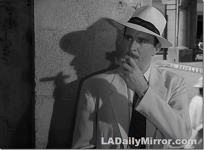 Man in tropical hat and suit smoking a cigar. Man in tropical hat and suit smoking a cigar.