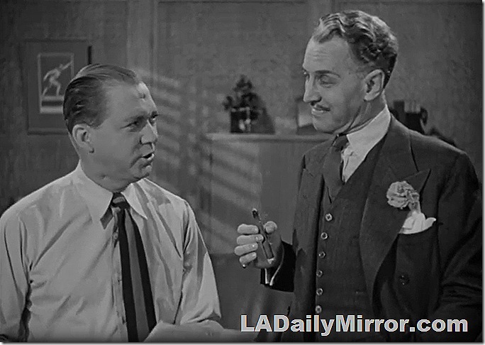 Lee Tracy in shirt and tie; Otto Kruger in three-piece suit, holding a cigar 