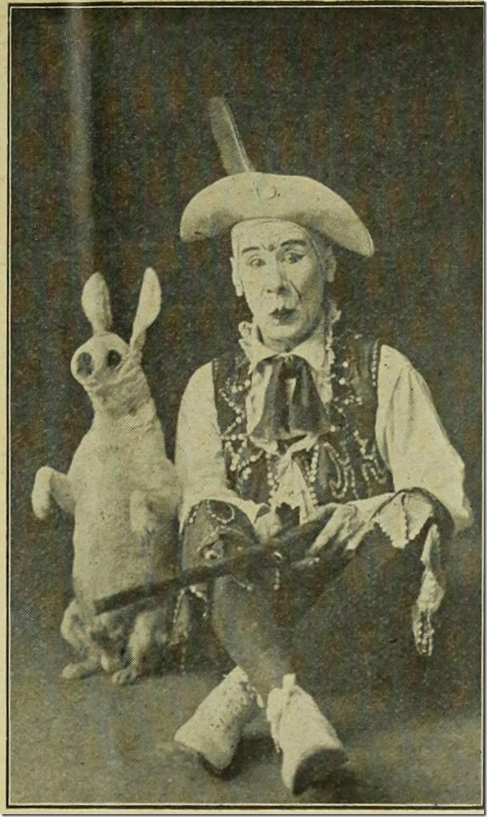 Tote DuCrow in clown makeup with dog in rabbit outfit. 