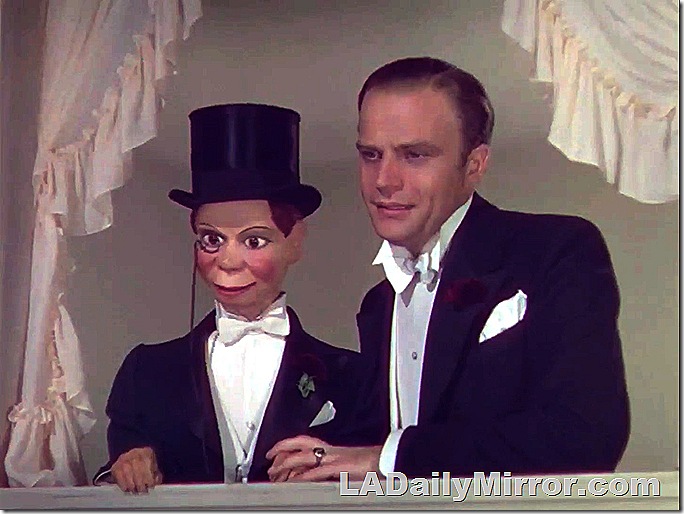 Dummy in top hat and monocle. Also a man in a tuxedo. 