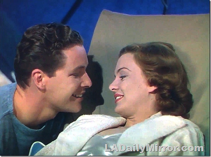 man and woman, very close together. They are smiling. 