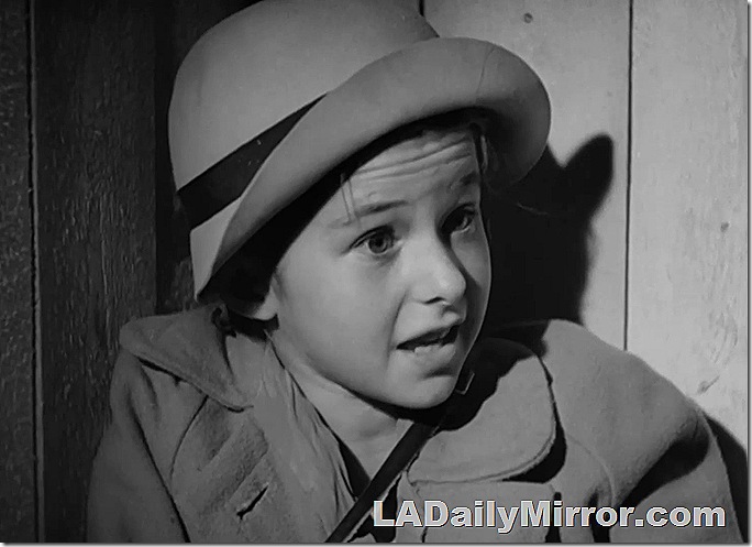 Mystery child wearing hat and coat. 