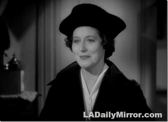 Woman wearing hat and coat. 