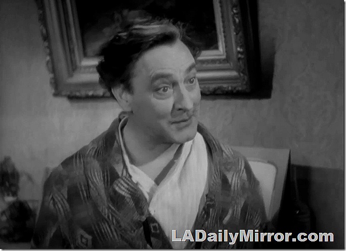 Man, somewhat disheveled, in robe and pajamas