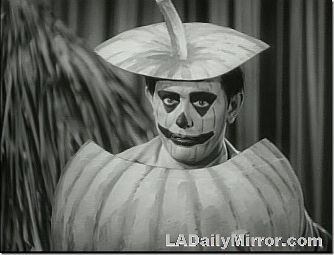 Man in makeup as pumpkin.