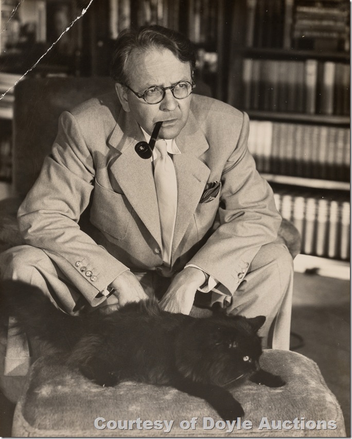 Photo of Raymond Chandler in a suit and tie, smoking a pipe, next to a black cat on a hassock. Photo of Raymond Chandler in a suit and tie, smoking a pipe, next to a black cat on a hassock.