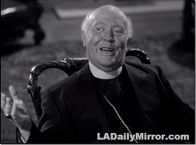 Bald man in clerical collar. 