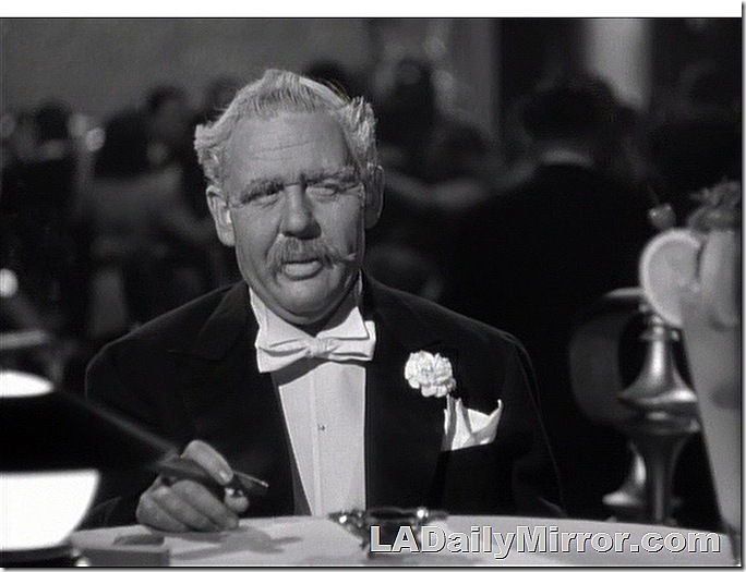 Older man in tuxedo, smoking a cigar. 