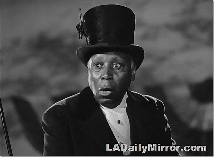 Man in top hat and formal wear. 