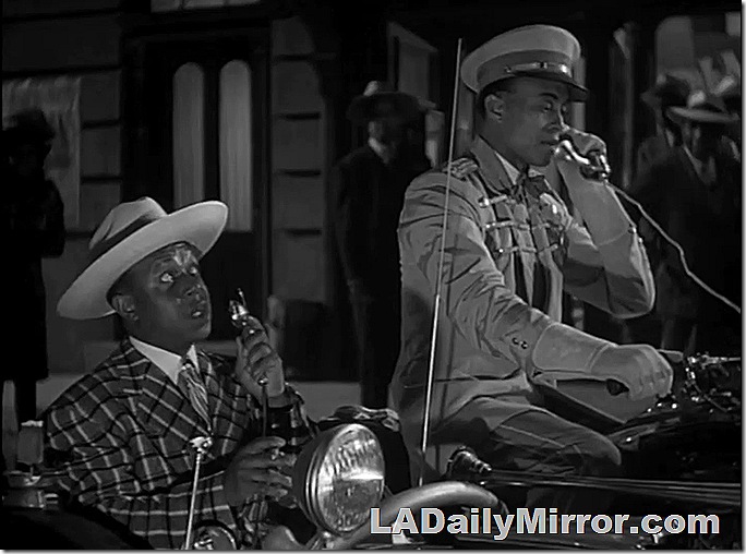 Man in Zoot Suit in motorcycle sidecar talking to 'chauffeur'