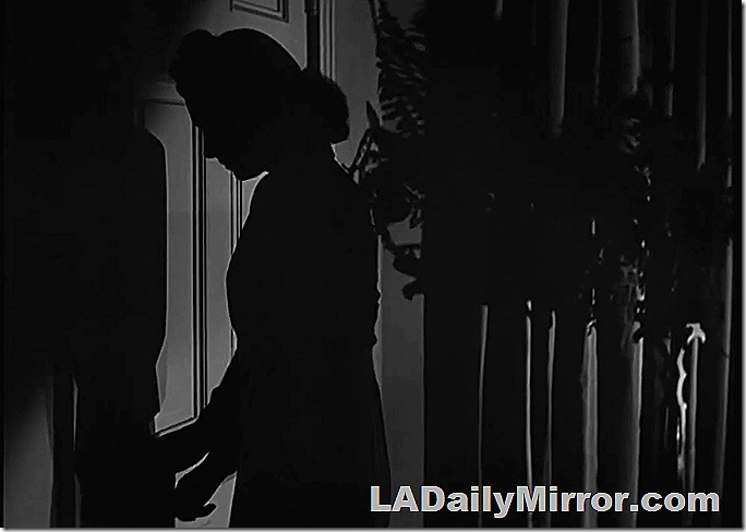 Silhouette of a woman answering the door. 