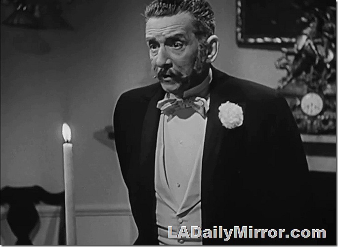 Man with mustache in tuxedo. 